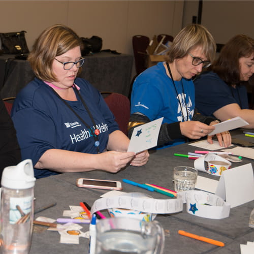 Xcenda team making cancer card cards