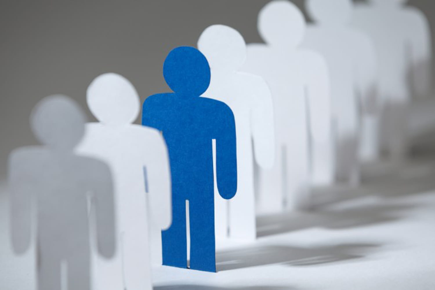 Different colored figure among many other figures