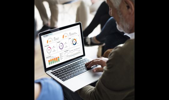 businessman with laptop reviewing a dashboard