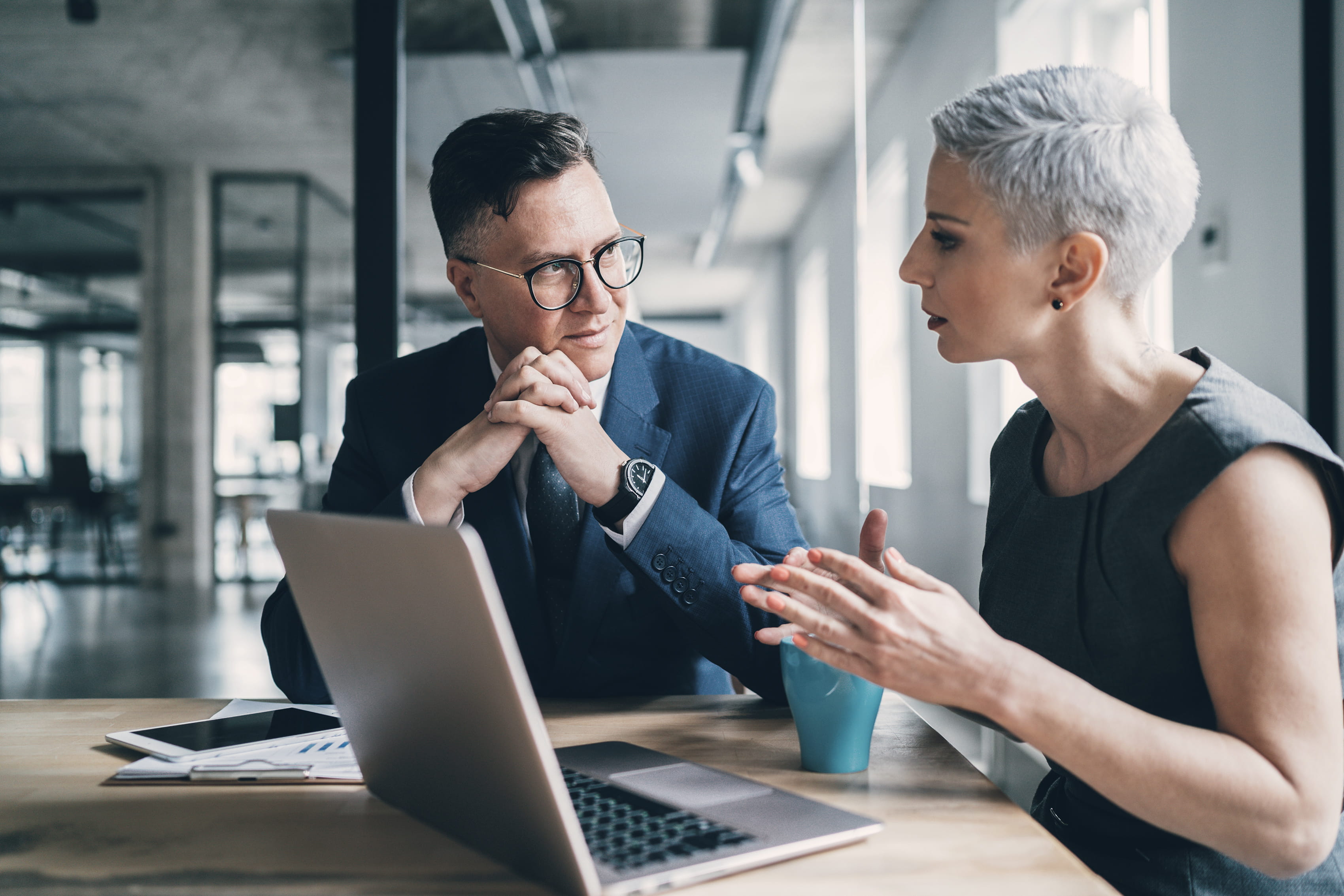 professionals talking with laptop