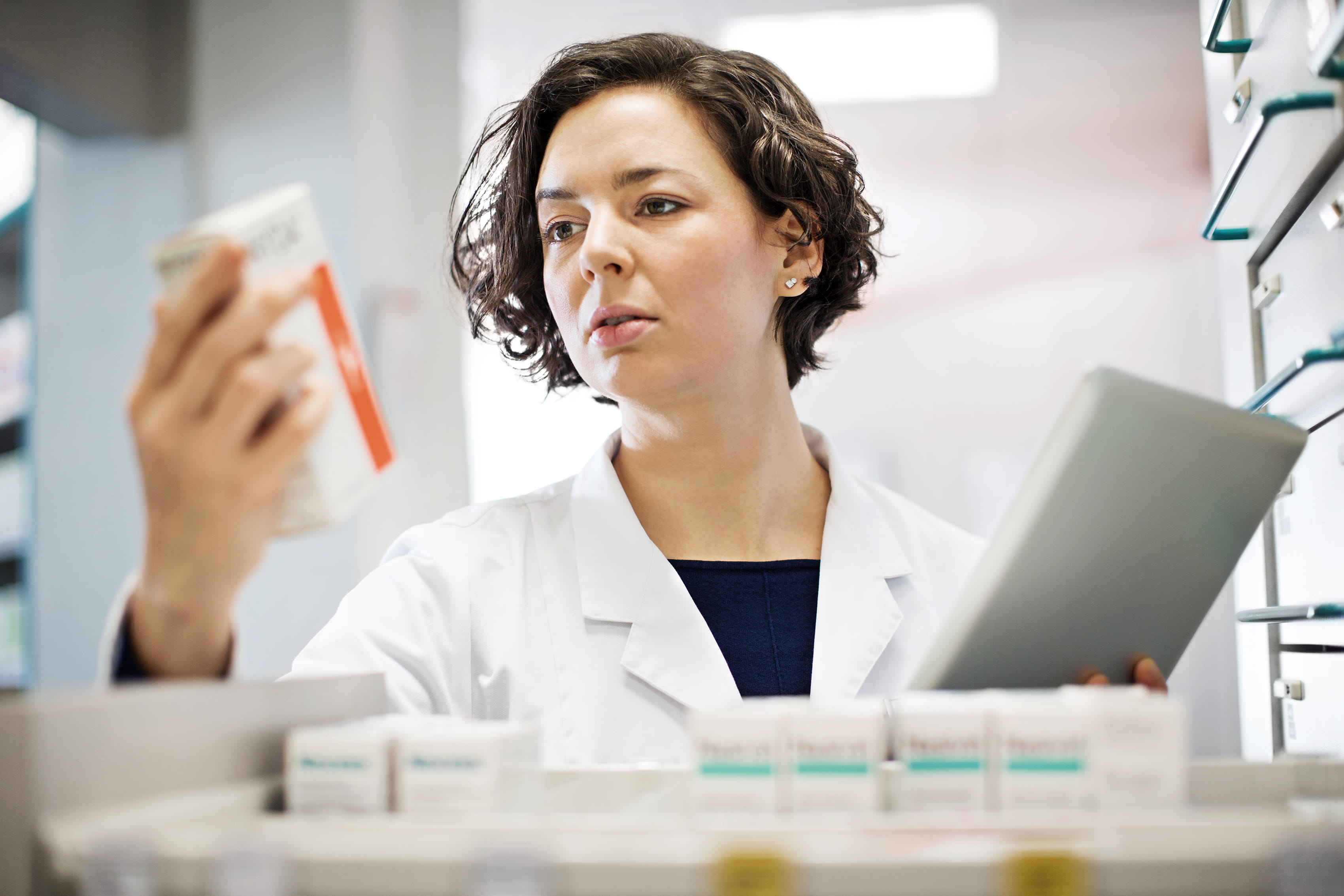 pharmacist looking at bottle