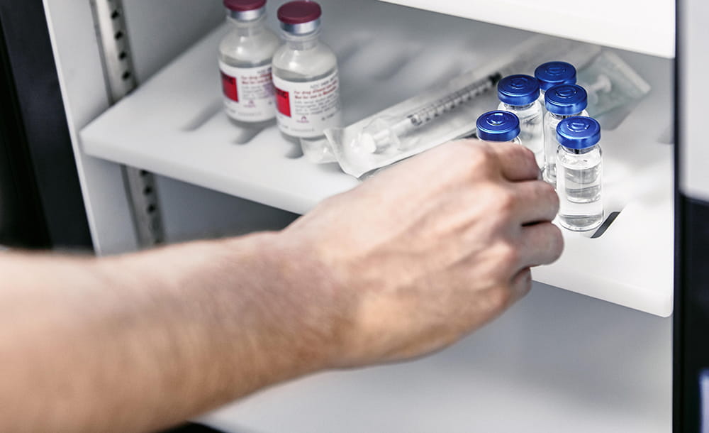 hand reaching for vials