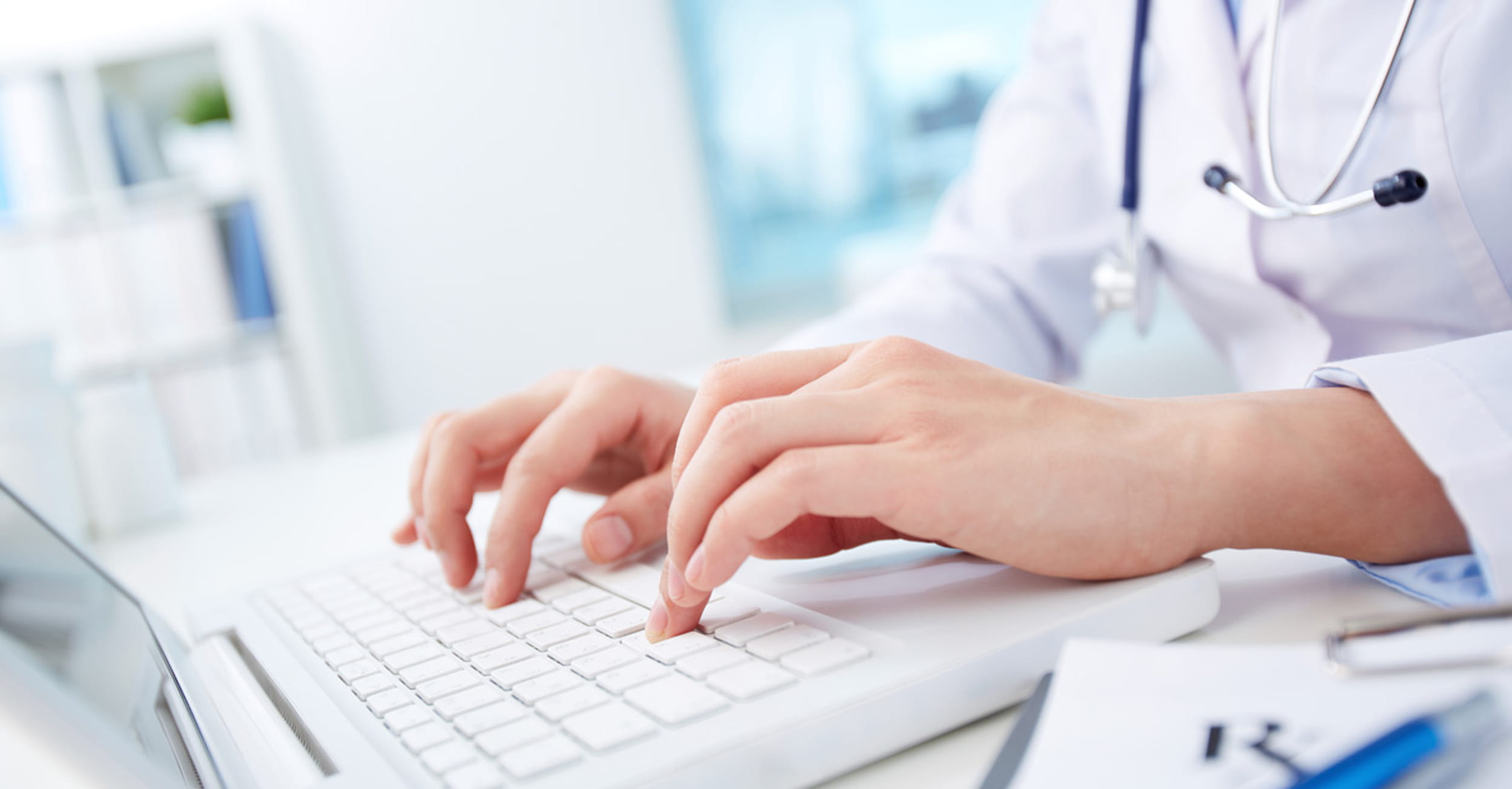 Healthcare professional working on laptop